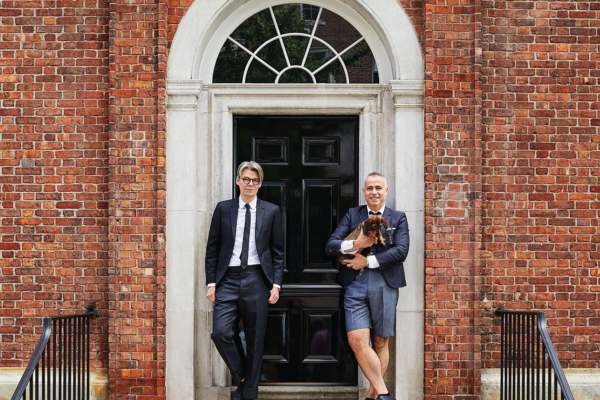 Thom Browne and Andrew Bolton in front of their lovingly restored home at 1 Sutton Place. Image courtesy of Architectural Digest. Photo by William Abranowicz. Layout by Betsy Blazar.